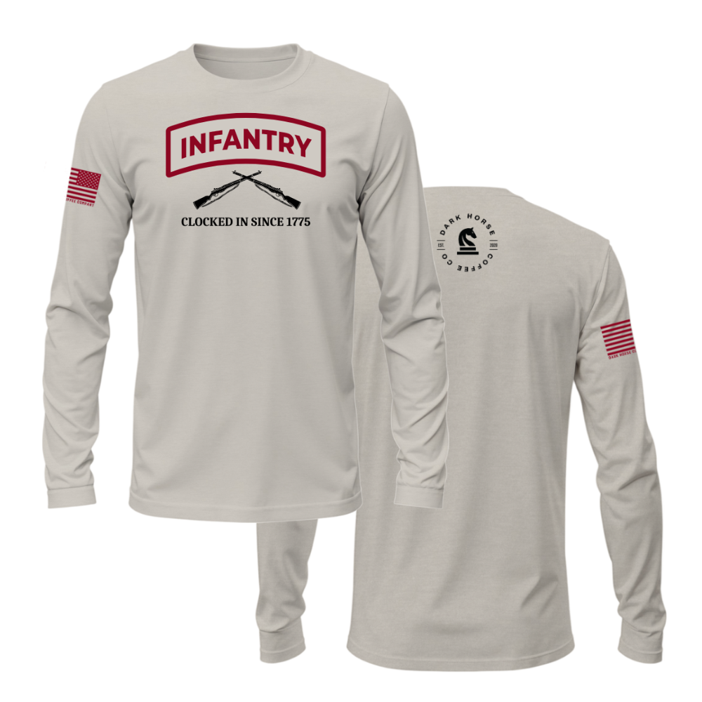 Sandstone Infantry long sleeve shirt with red and black text “Clocked In Since 1775” and crossed rifles — veteran-inspired design.