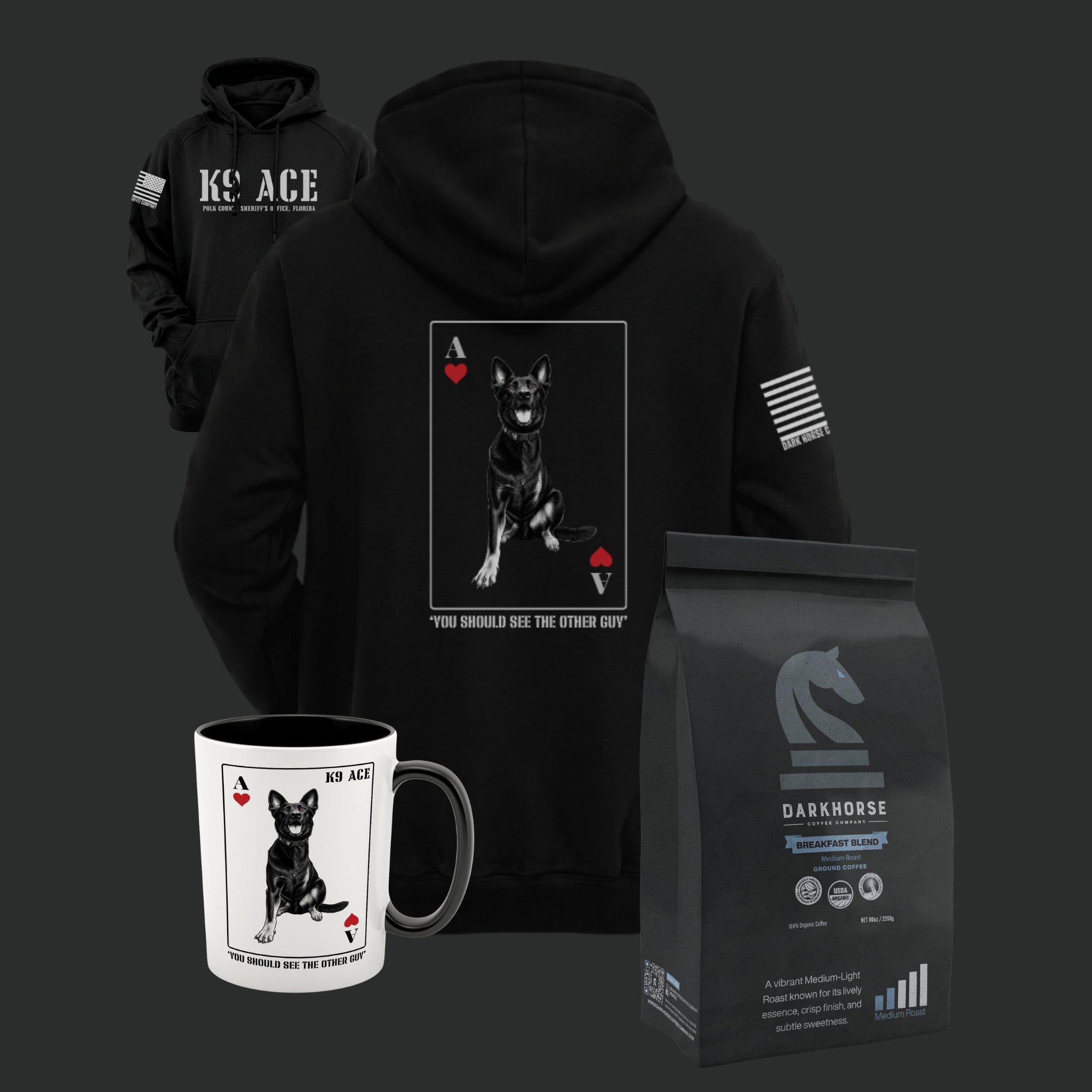 K9 ACE Other Guy Hoodie in Black, back and front, with 15oz ceramic mug and a 5 lb bag of Dark Horse coffee - The Whole Unit